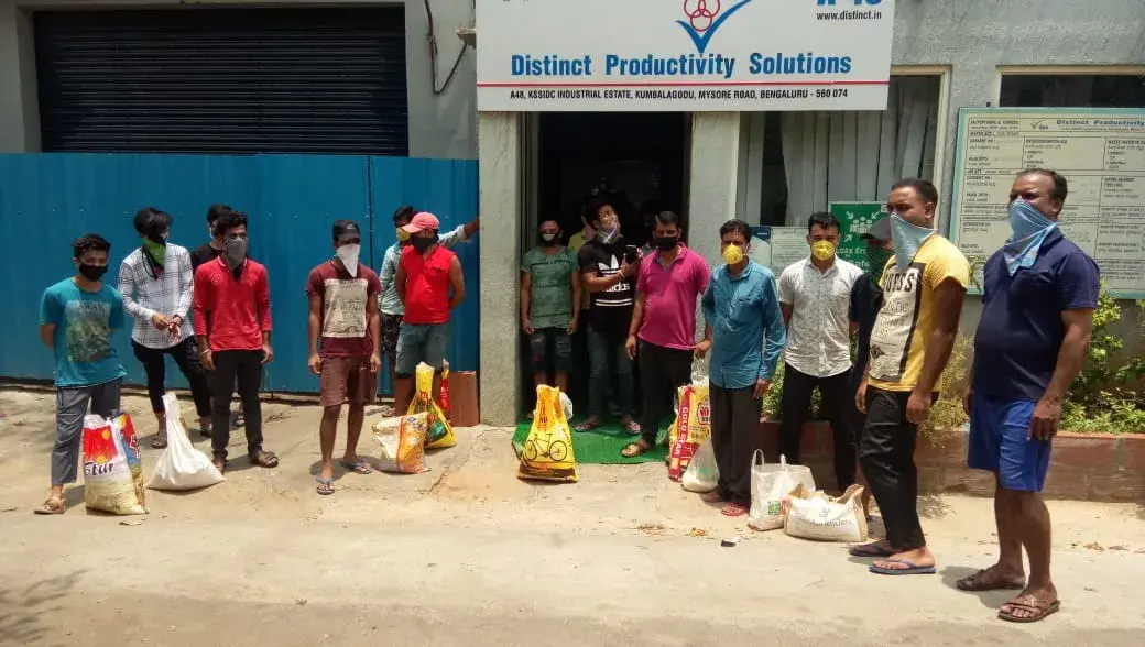 Employees with grocery kits outside the DPS facility